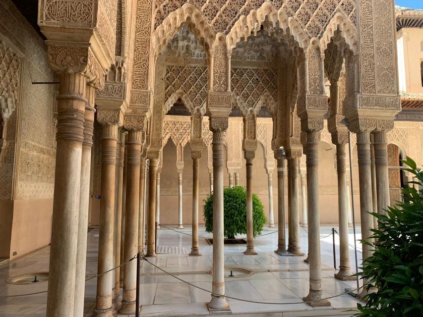 Granada: Alhambra Complex Guided Tour with Ticket - Meeting Point at the Access Pavilion: Orange Umbrella and the Guides Poster
